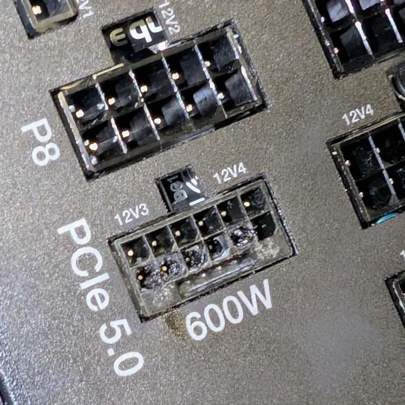 A close-up of a 'PCIe 5.0' 600W power connector shows visible damage and discoloration on the pins.