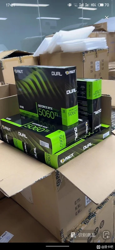Stacked boxes of Palit Dual GeForce RTX 5060 Ti graphics cards are visible inside an open cardboard packaging.