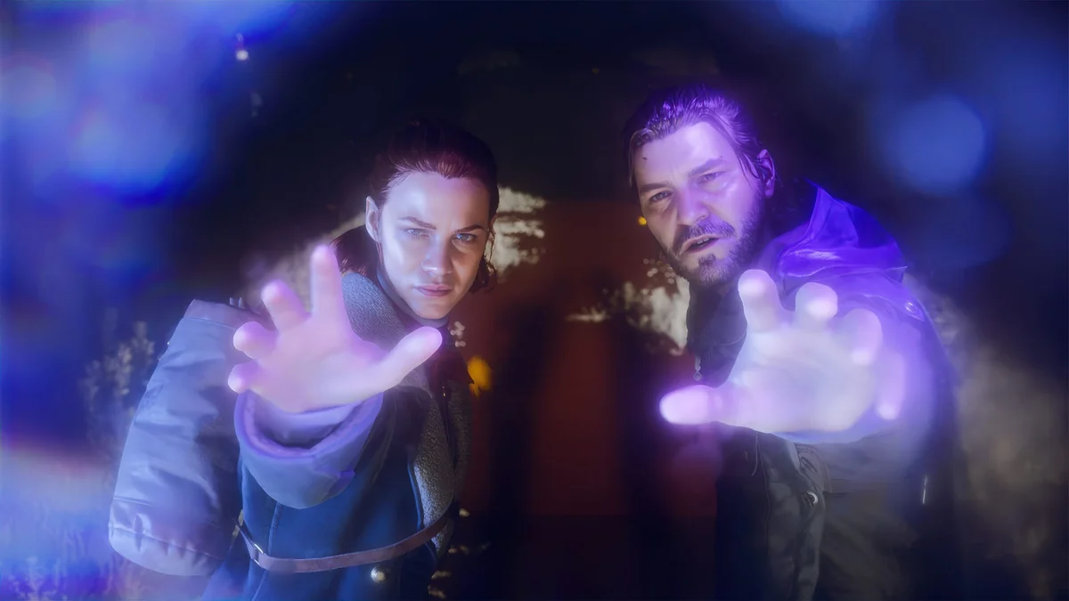 Two characters reaching towards the screen with glowing hands in a dramatic scene from a video game.