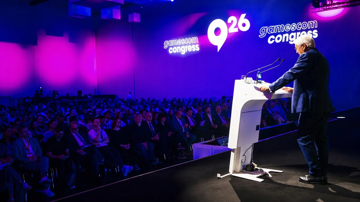 A speaker at the podium addresses an audience at 'gamescom congress 2026' under purple lighting.