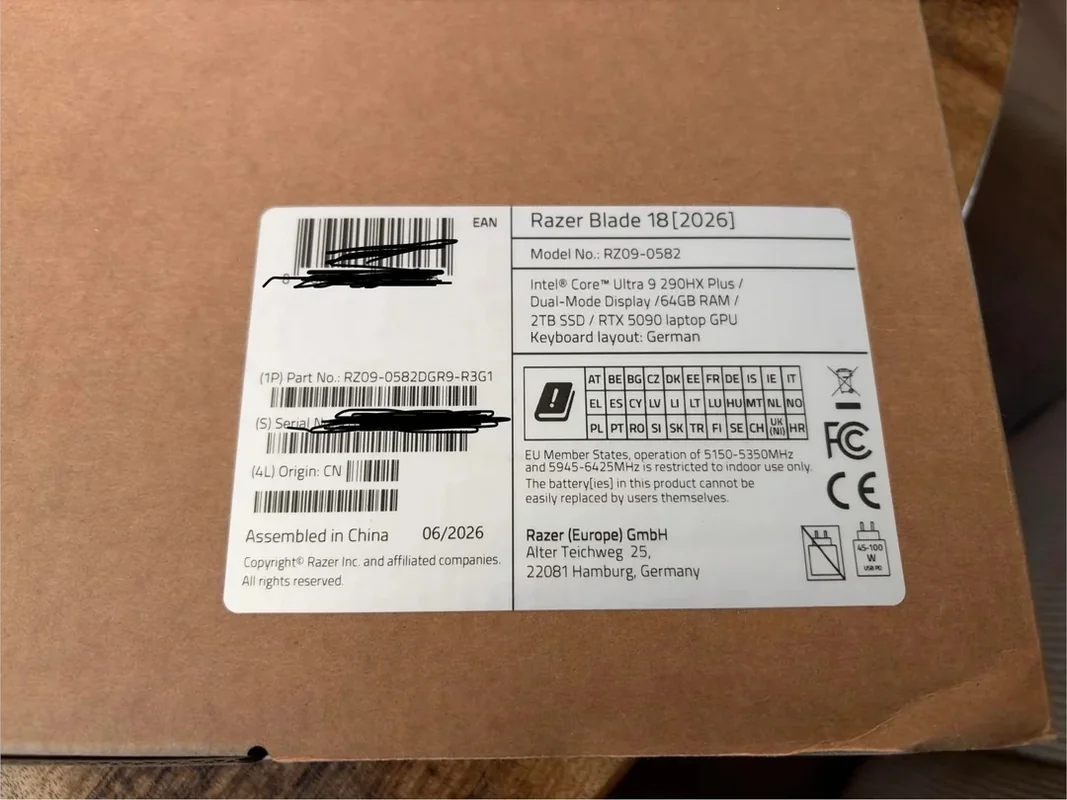 A product box label for the Razer Blade 18 [2026] model number RZ09-0582, featuring an Intel Core Ultra 9 290HX Plus, 64GB RAM, 2TB SSD, RTX 5090 GPU, and a German keyboard layout.