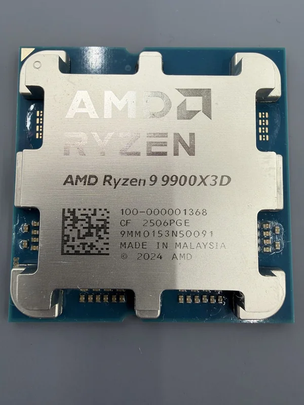 An AMD Ryzen 9 9900X3D processor with visible markings including 'MADE IN MALAYSIA' and a QR code.