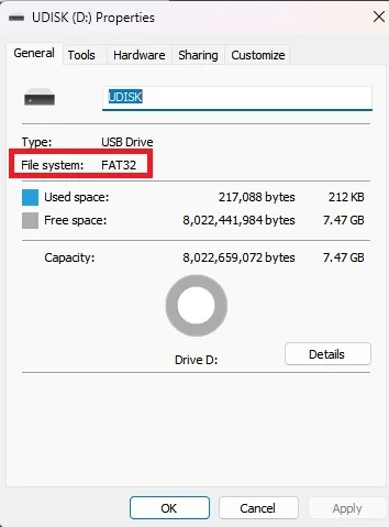 A USB Drive properties window on Windows shows the 'File system' as 'FAT32' with a capacity of 7.47 GB.